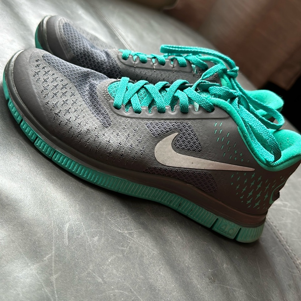 Turquoise and gray Nike running shoes